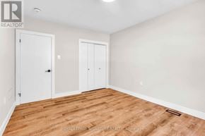 Newmarket (Gorham-College Manor) apartment for rent - A room with wooden flooring and two white doors.