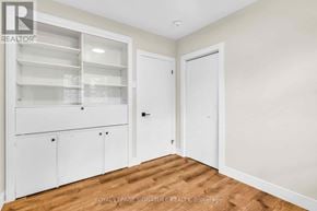 Newmarket (Gorham-College Manor) apartment for rent - A white cabinet with glass doors is in a room with a wooden floor.