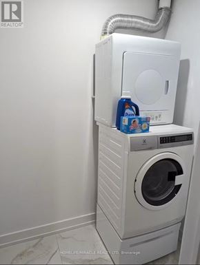 Toronto (Mimico) apartment for rent - A white washing machine with a dryer on top of it.