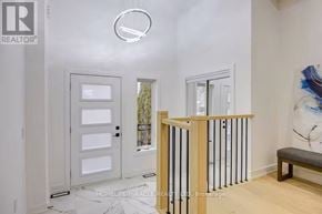 Toronto (Mimico) apartment for rent - A white door with a glass window is in a room with a wooden railing.