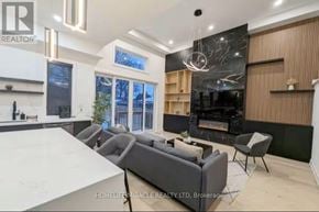 Toronto (Mimico) apartment for rent - A modern living room with a fireplace and a large window.