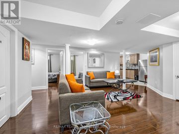 Brampton (Credit Valley) apartment for rent - A living room with a grey couch and orange pillows.