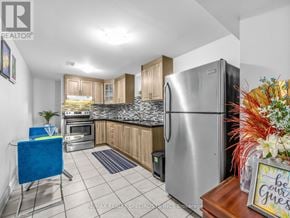 Brampton (Credit Valley) apartment for rent - A kitchen with a stainless steel refrigerator and a blue chair.
