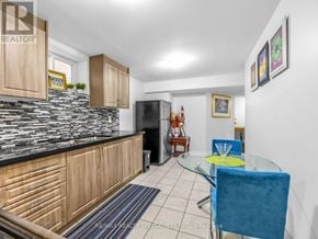 Brampton (Credit Valley) apartment for rent - A kitchen with a black counter top and wooden cabinets.
