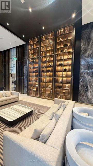 Toronto (Mount Pleasant West) condo for rent - A modern living room with a large sofa and a unique wall panel.