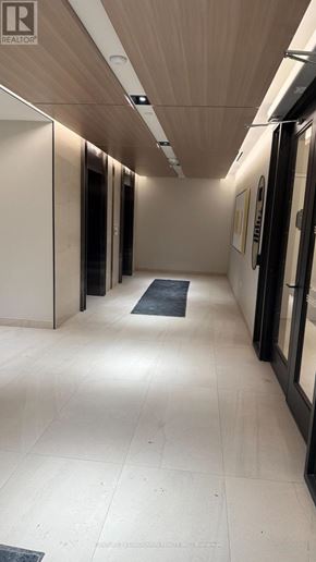 Toronto (Mount Pleasant West) condo for rent - A long hallway with a black mat on the floor.