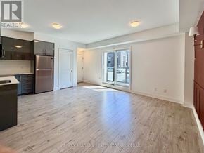 Niagara Falls (Arad/Fallsview) condo for rent - A spacious room with wooden flooring and a large window.