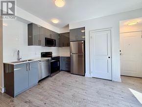 Niagara Falls (Arad/Fallsview) condo for rent - A kitchen with a refrigerator, oven, and microwave.