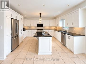 Richmond Hill (Doncrest) apartment for rent - A kitchen with white cabinets and a black countertop.