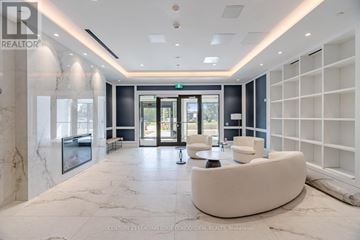 Toronto (Humber Heights) condo for rent - A spacious lobby with a white marble floor and a green exit sign above the door.