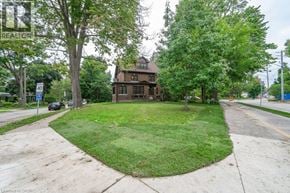 Kitchener apartment for rent - A house with a lawn in front of it.