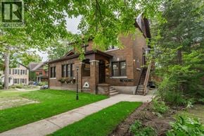 Kitchener apartment for rent - A house with a green lawn in front of it.