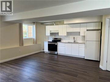 Waterloo apartment for rent - A kitchen with white cabinets and a black stove top oven.