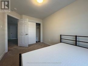 Welland (Dain City) apartment for rent - A bedroom with a bed, dresser, and closet.