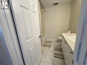 Welland (Dain City) apartment for rent - A bathroom with a white door and a white toilet.