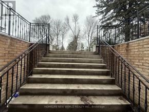 Markham (Bullock) apartment for rent - A set of stairs with a metal railing leading up to a cloudy sky.