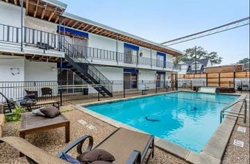 Houton apartment for rent - A small pool with a slide and a building in the background.