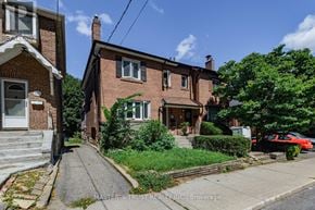 Toronto (Mount Pleasant West) apartment for rent - A red car is parked on the street in front of a brick house.