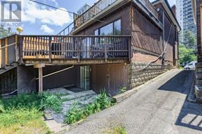 Toronto (Mount Pleasant West) apartment for rent - A building with a balcony is situated on a street.