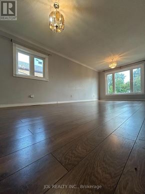 Toronto (Wexford-Maryvale) apartment for rent - A room with wooden flooring and two windows.
