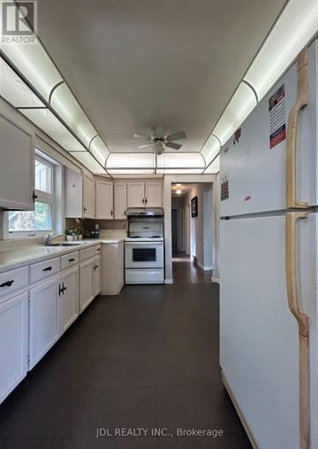 Toronto (Wexford-Maryvale) apartment for rent - A kitchen with white cabinets and a white refrigerator.