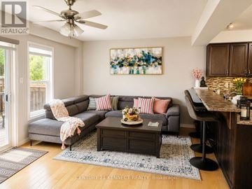 Waterloo apartment for rent - A living room with a grey couch, a coffee table, and a painting on the wall.