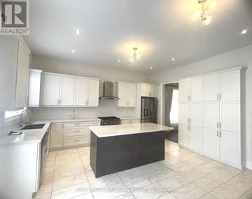Aurora (Bayview Southeast) apartment for rent - A spacious kitchen with white cabinets and a central island.