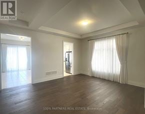 Aurora (Bayview Southeast) apartment for rent - A spacious room with wooden floors and white walls.