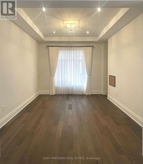 Aurora (Bayview Southeast) apartment for rent - A room with wooden flooring and a window with curtains.