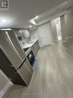 Brampton (Northwest Sandalwood Parkway) apartment for rent - A kitchen with a stainless steel refrigerator and wooden flooring.