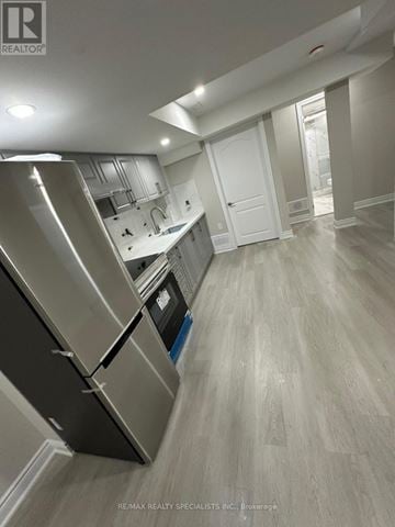 Brampton (Northwest Sandalwood Parkway) apartment for rent - A kitchen with a stainless steel refrigerator and wooden flooring.