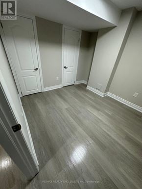 Brampton (Northwest Sandalwood Parkway) apartment for rent - A room with wood flooring and white walls.