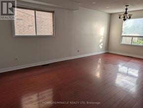 Brampton (Heart Lake West) apartment for rent - A room with wooden flooring and a window with blinds.