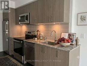 Toronto (Humber Heights) condo for rent - A kitchen with a sink, microwave, and refrigerator.