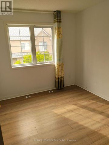 Markham (Unionville) townhouse for rent - A room with a window and a curtain with a pattern on it.