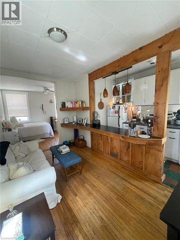 London apartment for rent - A living room with a white couch and a wooden floor.