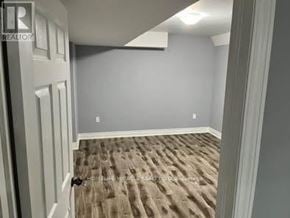 Brampton (Sandringham-Wellington) townhouse for rent - A room with a carpeted floor and a door on the left.