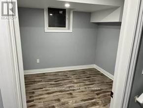 Brampton (Sandringham-Wellington) townhouse for rent - A room with a window and wooden flooring.