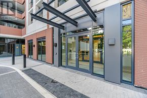 Toronto (Humber Heights) condo for rent - A modern building entrance with glass doors and a covered walkway.