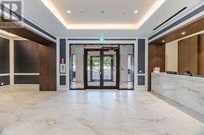 Toronto (Humber Heights) condo for rent - A reception area with a marble floor and a green exit sign.
