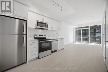 Toronto (Humber Heights) condo for rent - A modern kitchen with white cabinets and stainless steel appliances.