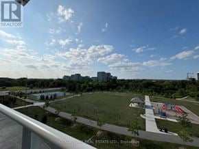 Markham (Unionville) condo for rent - A park with a playground and a pond is visible from a balcony.