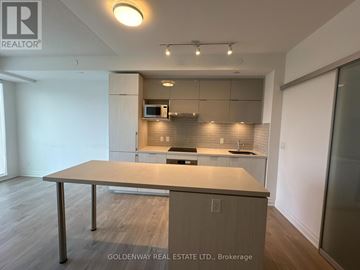Markham (Unionville) condo for rent - A modern kitchen with a dining table in the middle.