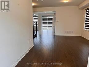 Southgate apartment for rent - A room with wooden flooring and white walls.