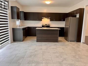 Southgate apartment for rent - A kitchen with dark brown cabinets and a white island.