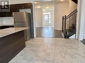 Southgate apartment for rent - A kitchen with a refrigerator, cabinets, and a countertop.