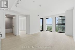 Toronto (Thorncliffe Park) condo for rent - A spacious, empty room with a view of a building outside the window.
