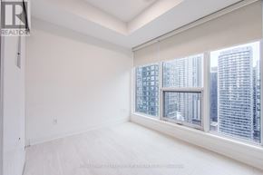 Toronto (Waterfront Communities) condo for rent - A white room with a window overlooking a cityscape.
