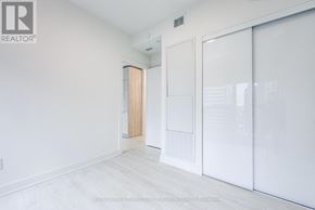 Toronto (Waterfront Communities) condo for rent - A white room with a sliding door and a wall-mounted light fixture.