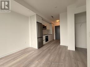 Toronto (Newtonbrook West) condo for rent - A kitchen area with a refrigerator, oven, and microwave.